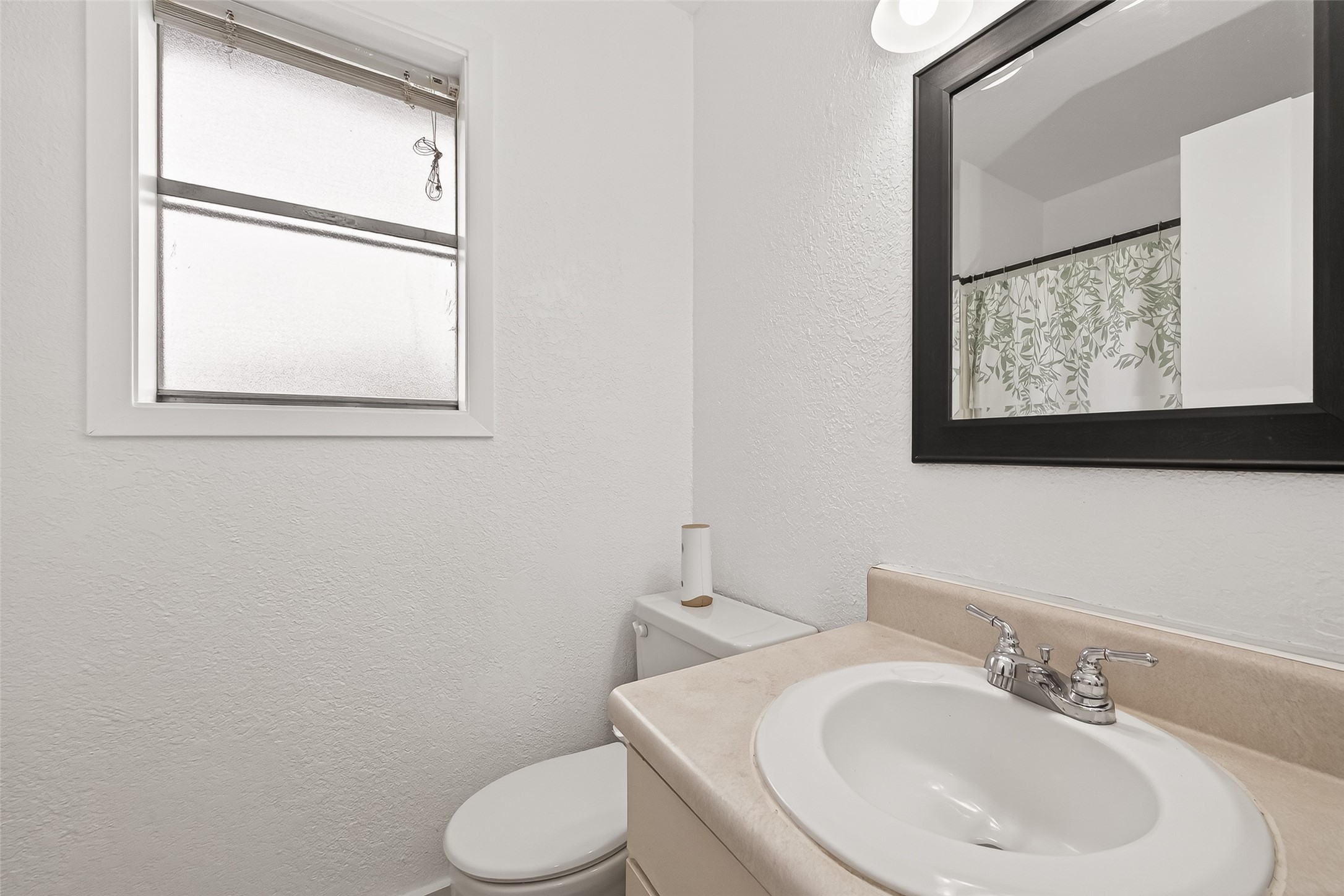 229 Austin Street Angleton, TX 77515 - Photo 23 of 36 a bathroom with a toilet sink and mirror