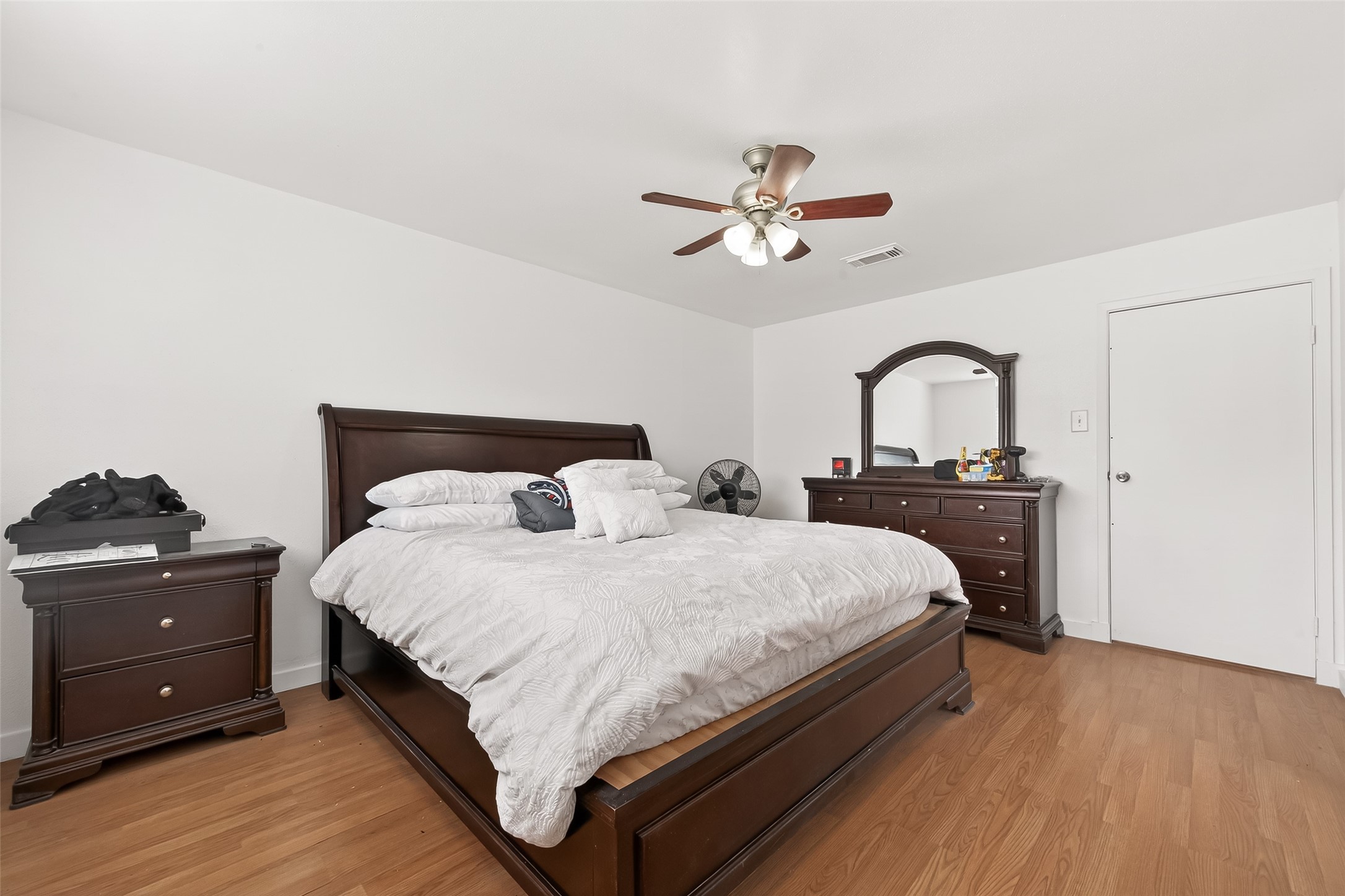 229 Austin Street Angleton, TX 77515 - Photo 25 of 36 a bedroom with a bed and a dresser