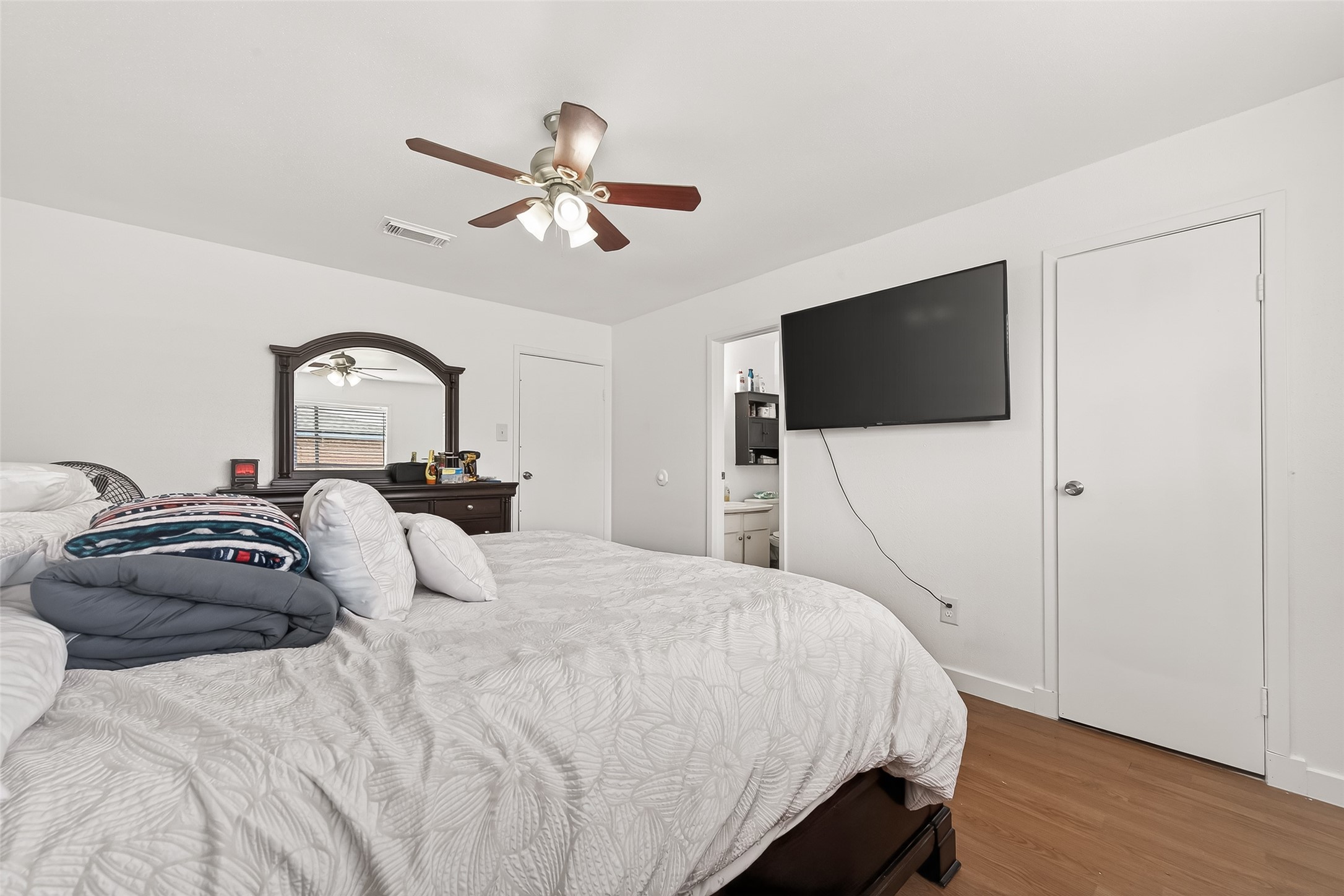 229 Austin Street Angleton, TX 77515 - Photo 26 of 36 a bedroom with a bed and a flat screen tv