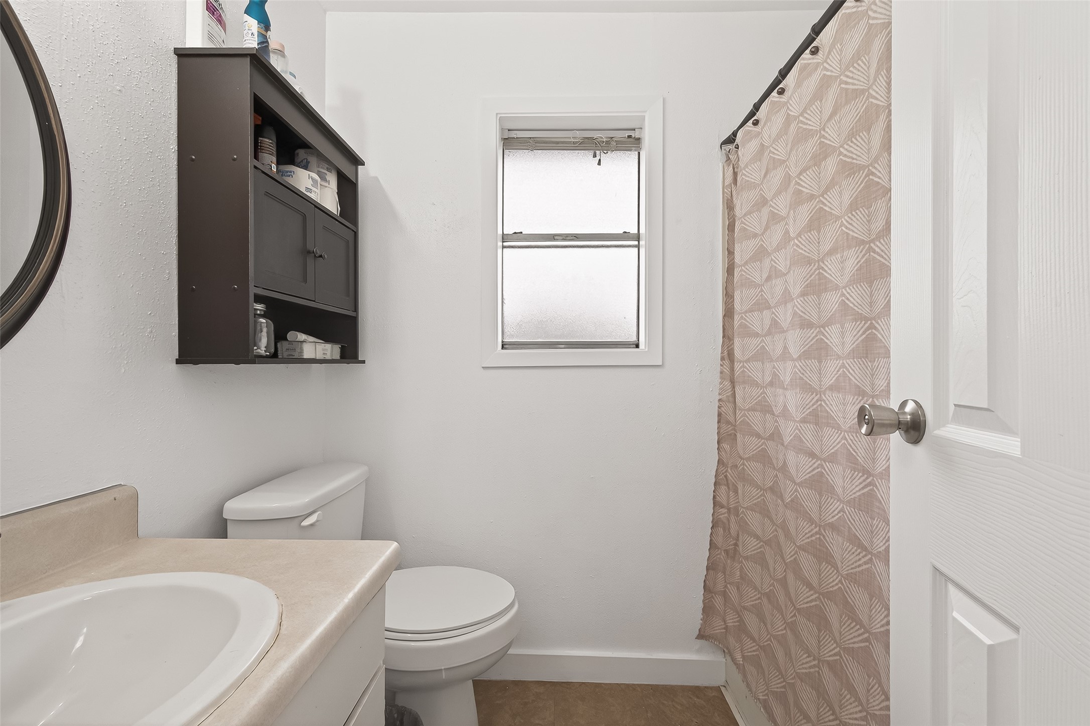 229 Austin Street Angleton, TX 77515 - Photo 28 of 36 a bathroom with a toilet a sink and a mirror