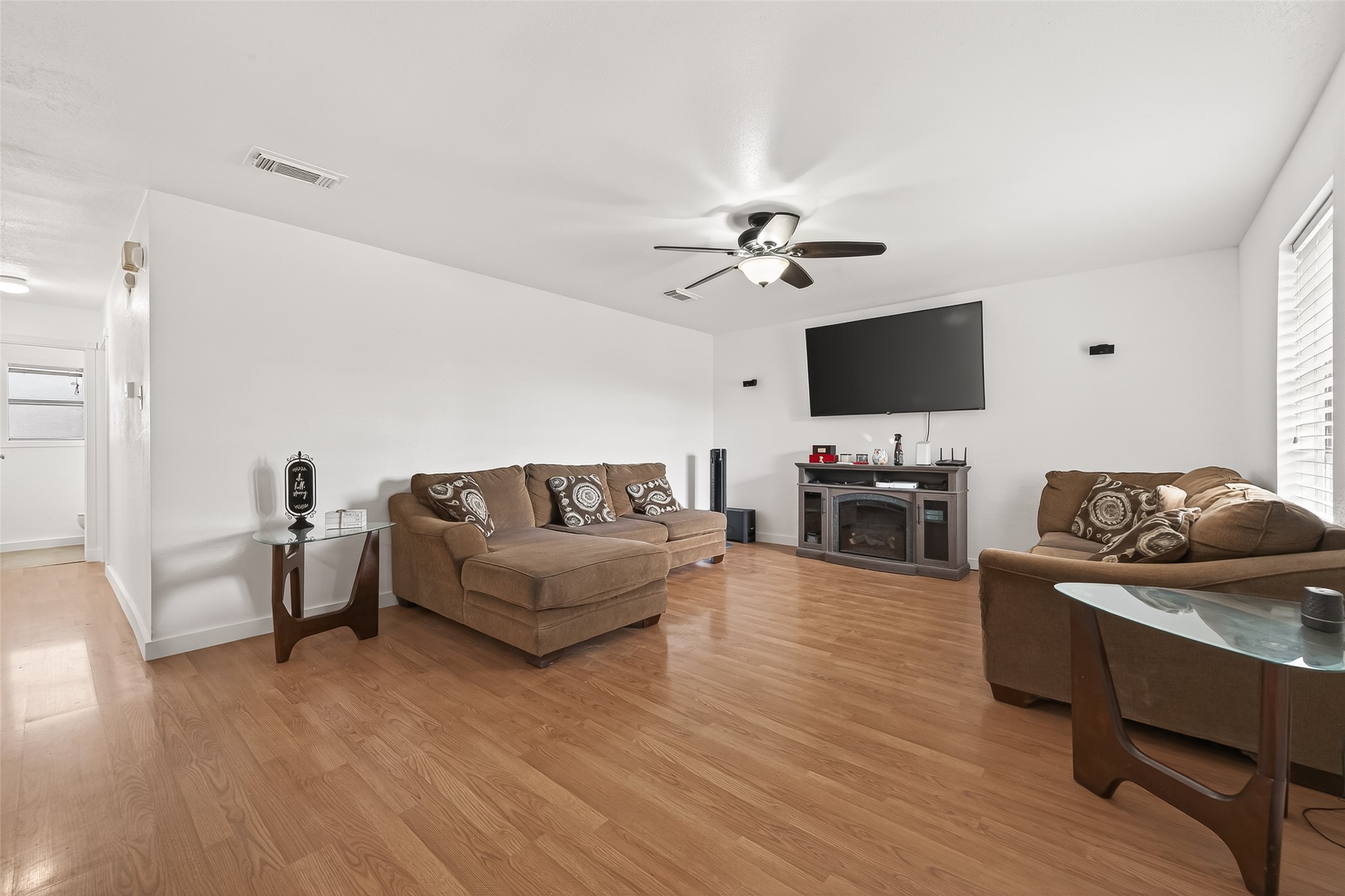 229 Austin Street Angleton, TX 77515 - Photo 4 of 36 a living room with furniture and a flat screen tv