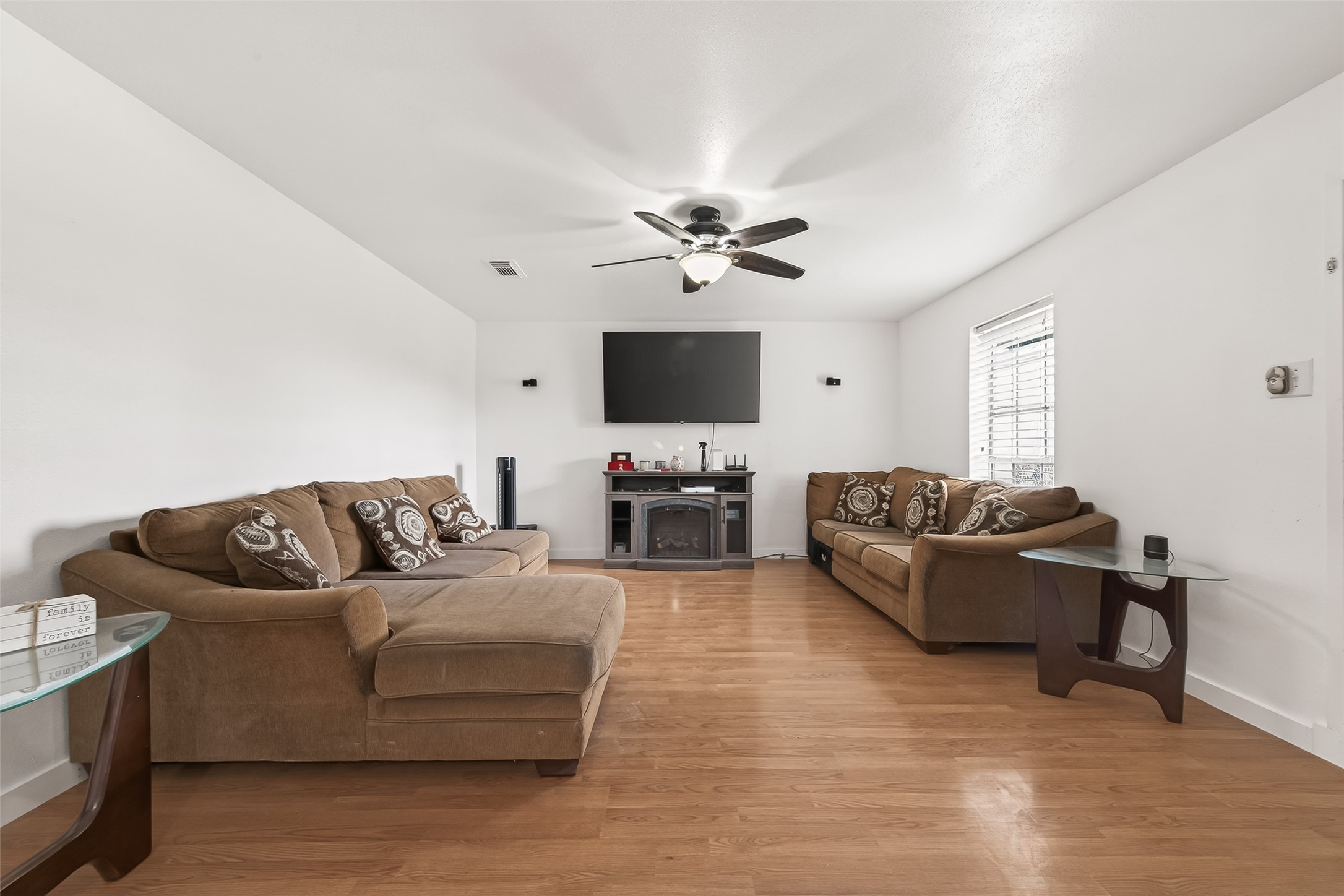 229 Austin Street Angleton, TX 77515 - Photo 5 of 36 a living room with furniture and a flat screen tv