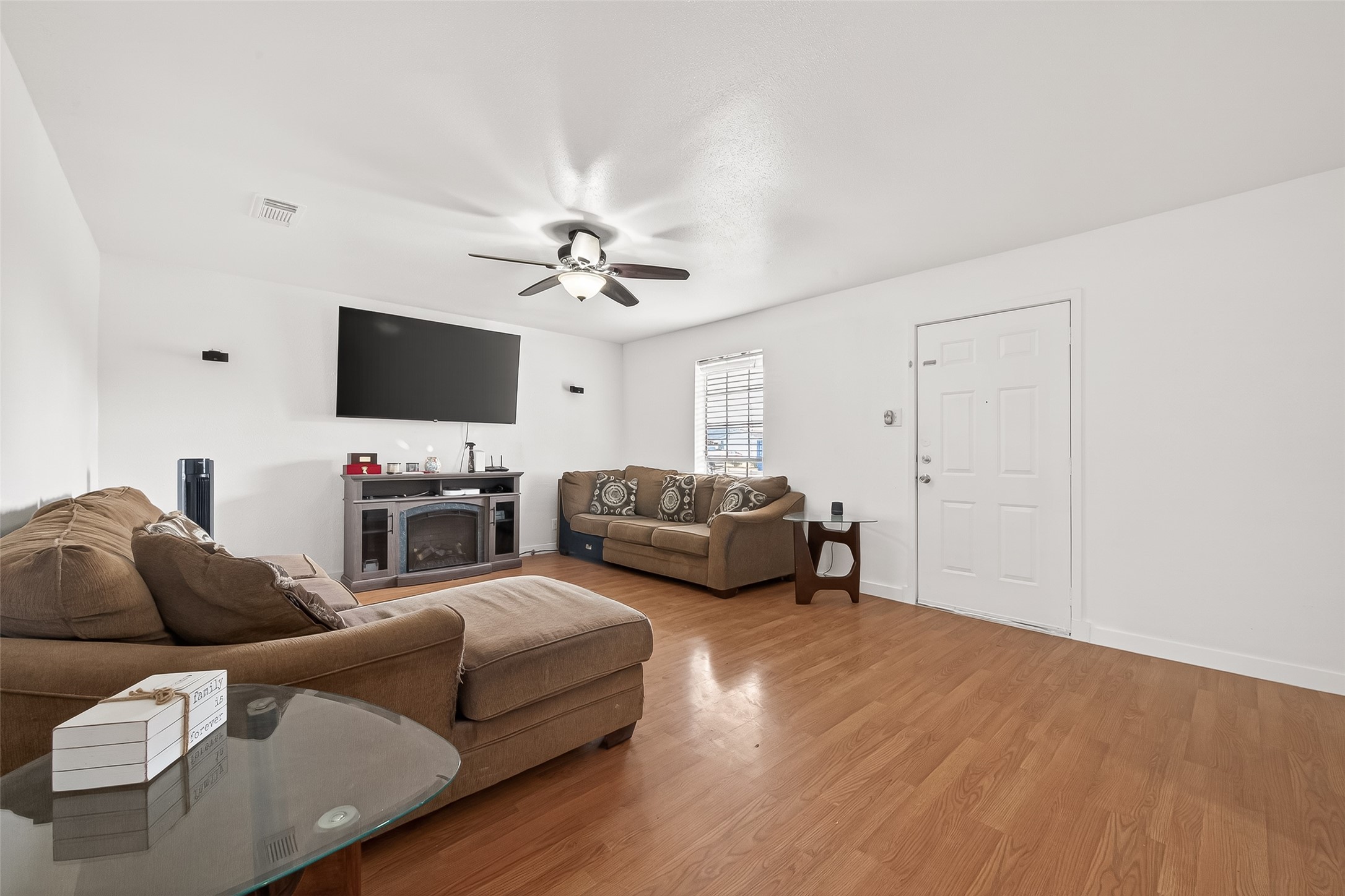 229 Austin Street Angleton, TX 77515 - Photo 6 of 36 a living room with furniture and a flat screen tv