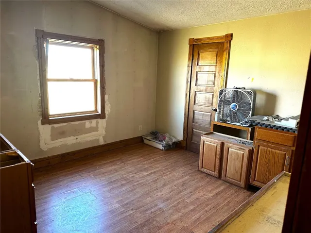 a view of a kitchen with wooden floor and furniture