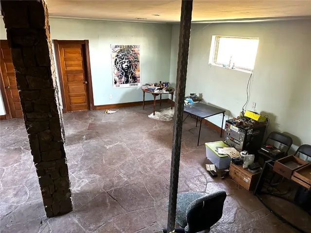 a view of a workspace with furniture and a window