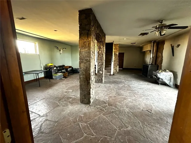 a view of a livingroom with furniture and a ceiling fan