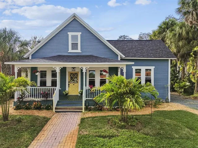 a front view of house with yard and outdoor seating
