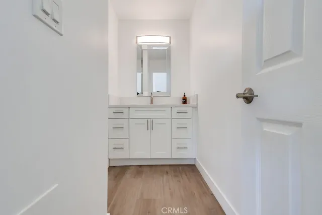 a bathroom with a sink a mirror and a vanity