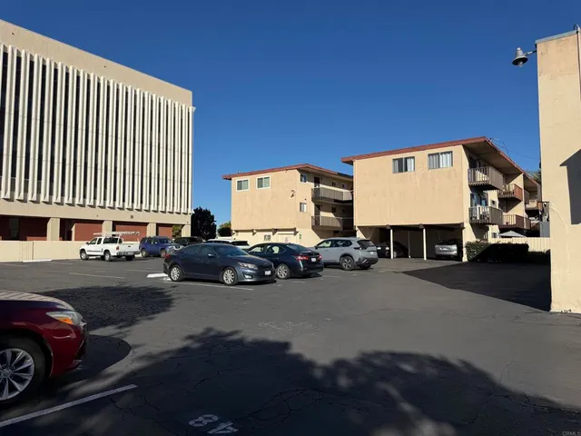 a view of a car park in front of a house