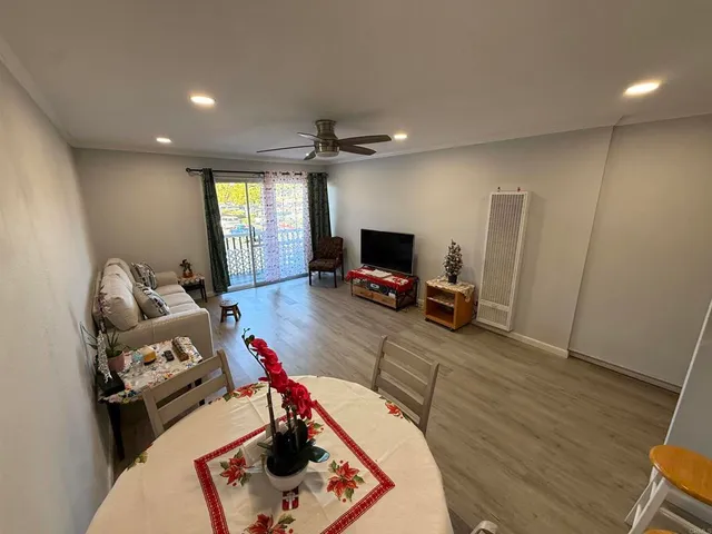 a living room with furniture gym equipment and a flat screen tv
