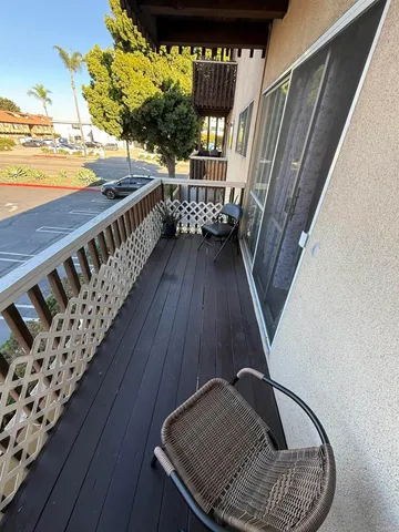 a view of balcony with wooden floor