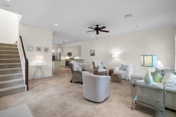 a living room with furniture a rug and white walls