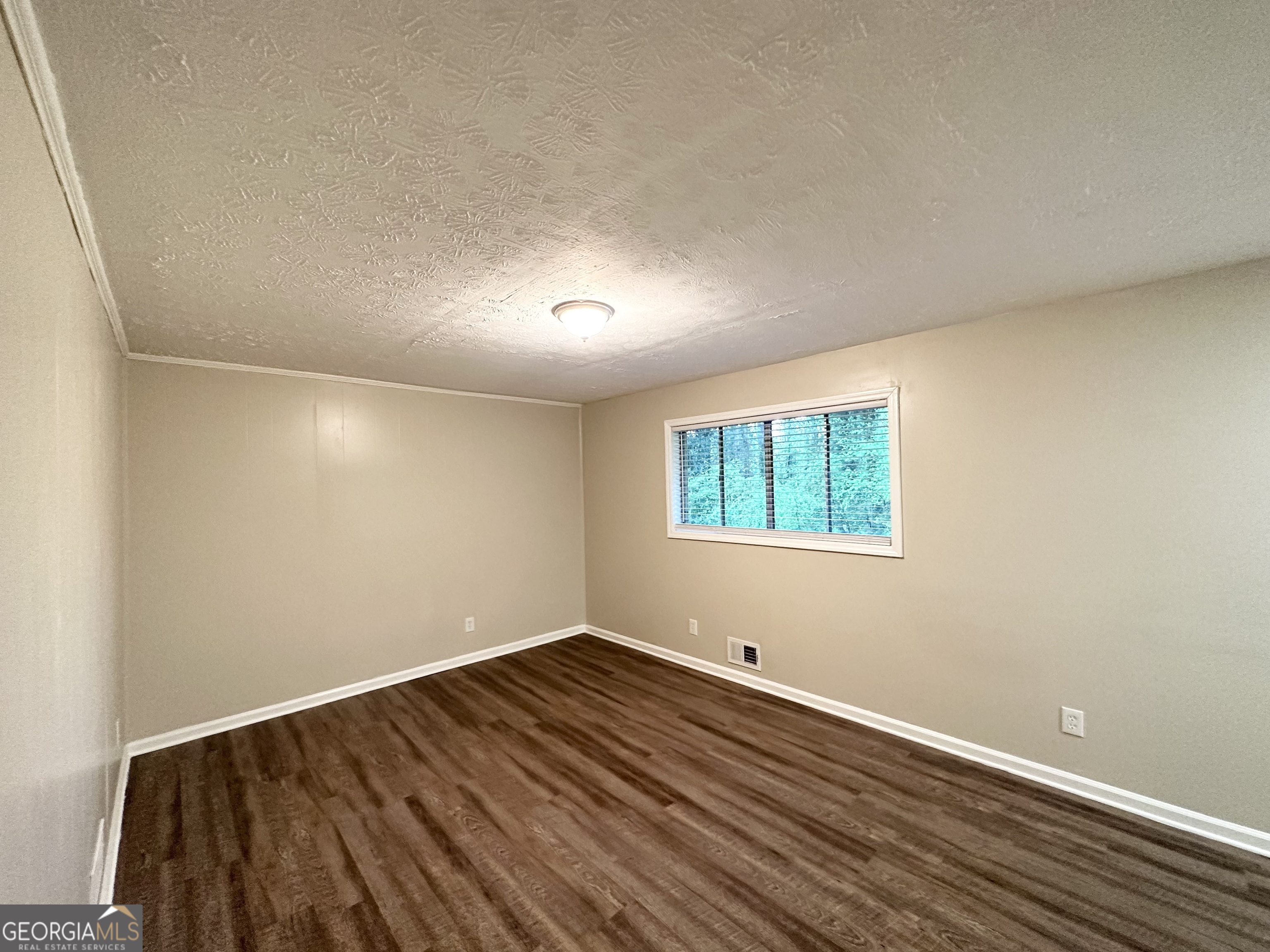 4505 Wonder Valley Trail Decatur, GA 30034 - Photo 5 of 24 an empty room with wooden floor and windows