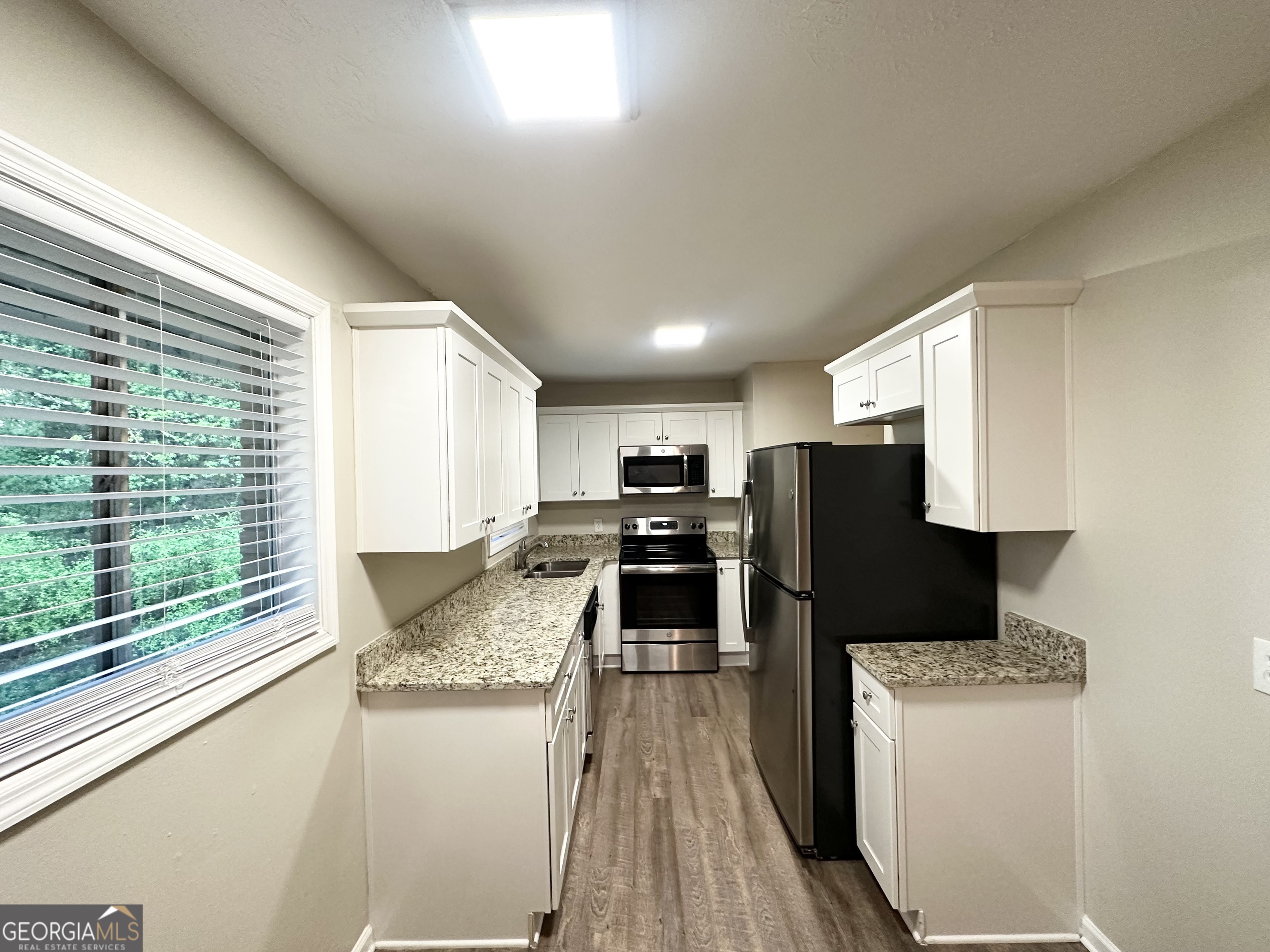 4505 Wonder Valley Trail Decatur, GA 30034 - Photo 7 of 24 a kitchen with refrigerator and microwave