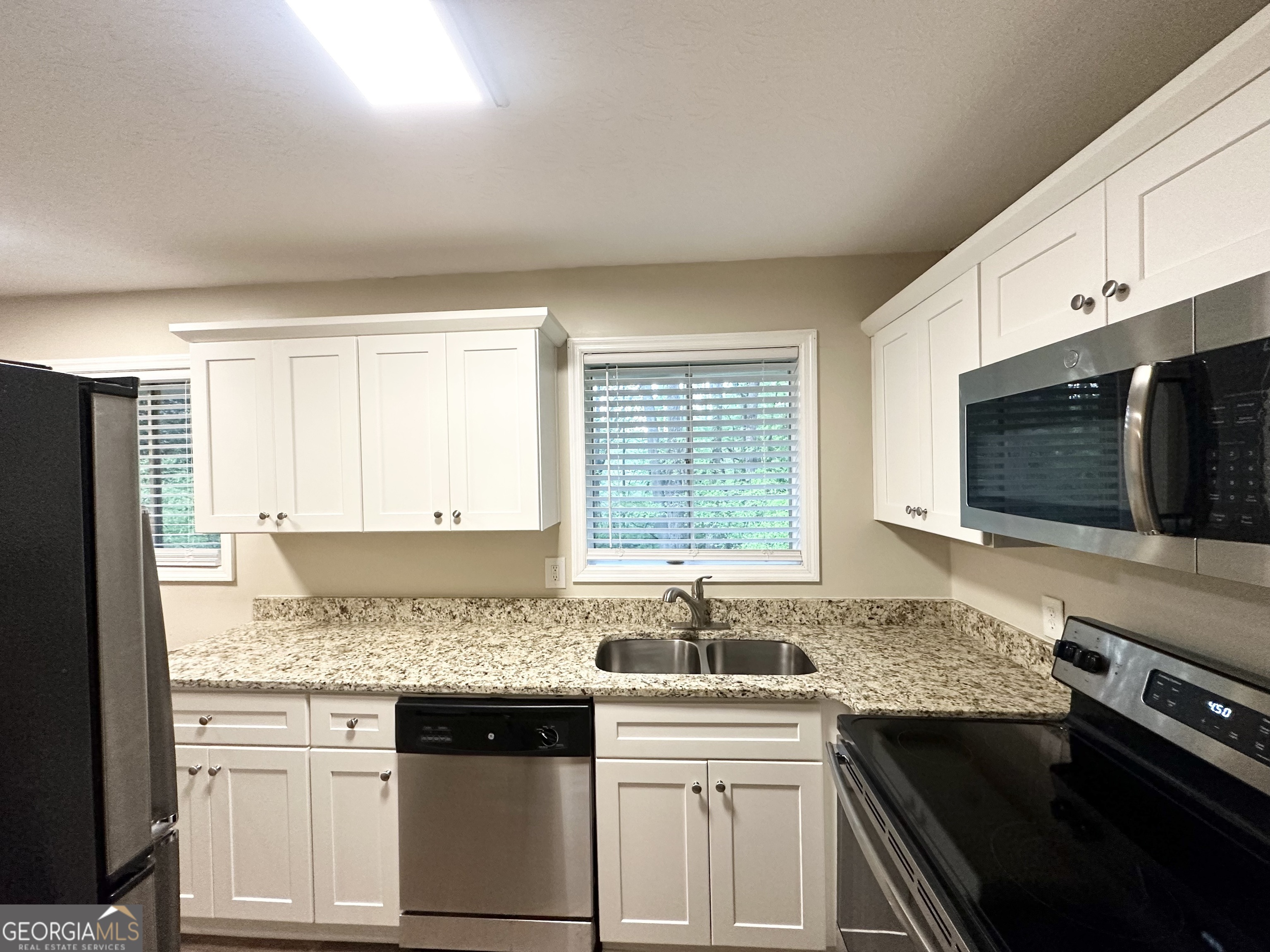 4505 Wonder Valley Trail Decatur, GA 30034 - Photo 8 of 24 a kitchen with stainless steel appliances granite countertop a sink stove and microwave