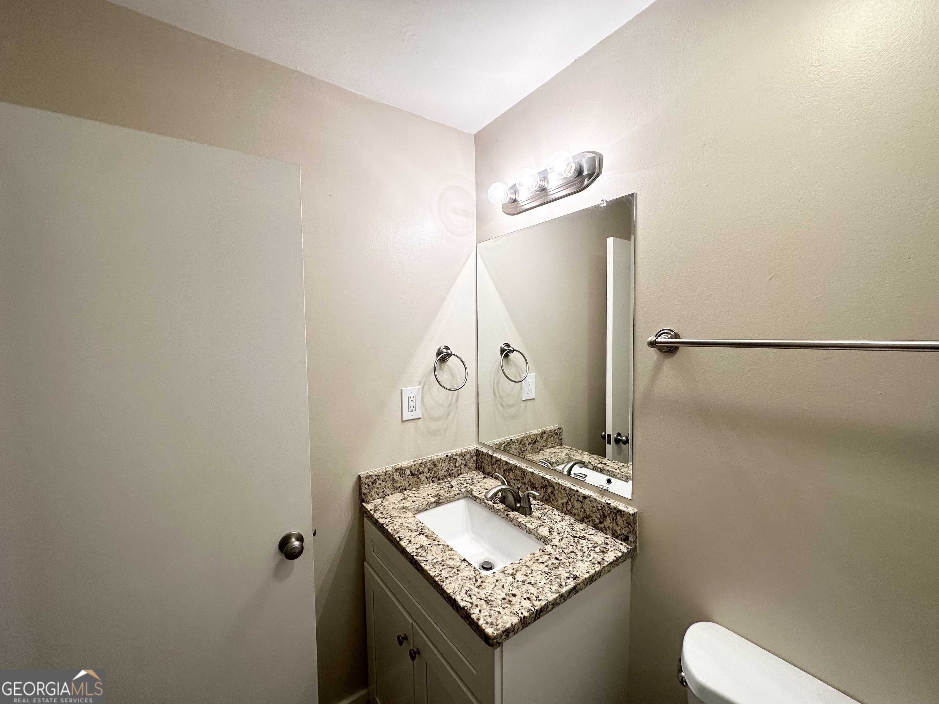 4505 Wonder Valley Trail Decatur, GA 30034 - Photo 10 of 24 a bathroom with a granite countertop sink and a mirror