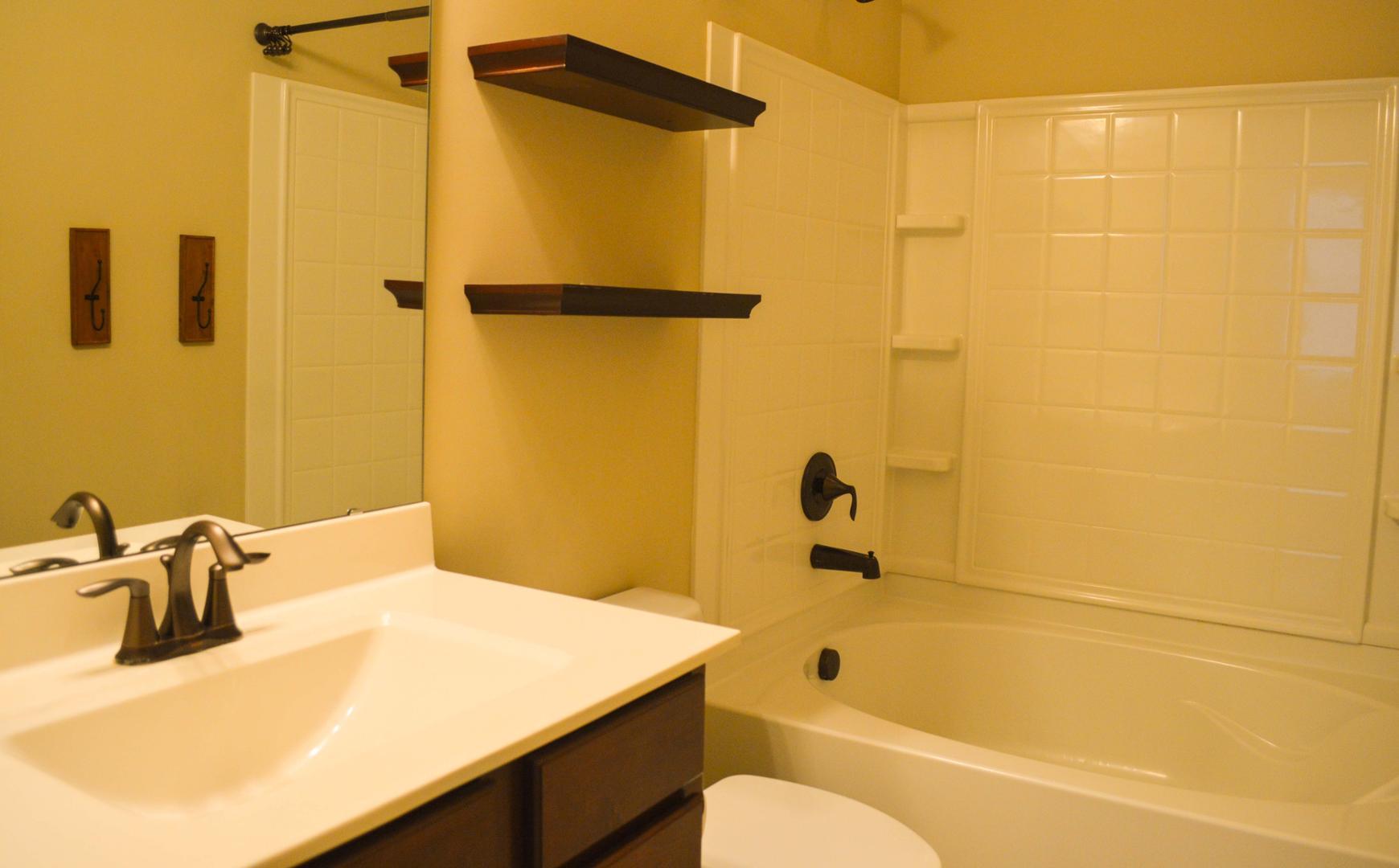 720 Wickham Ridge Road Apex, NC 27539 - Photo 13 of 24 a bathroom with a sink and a shower