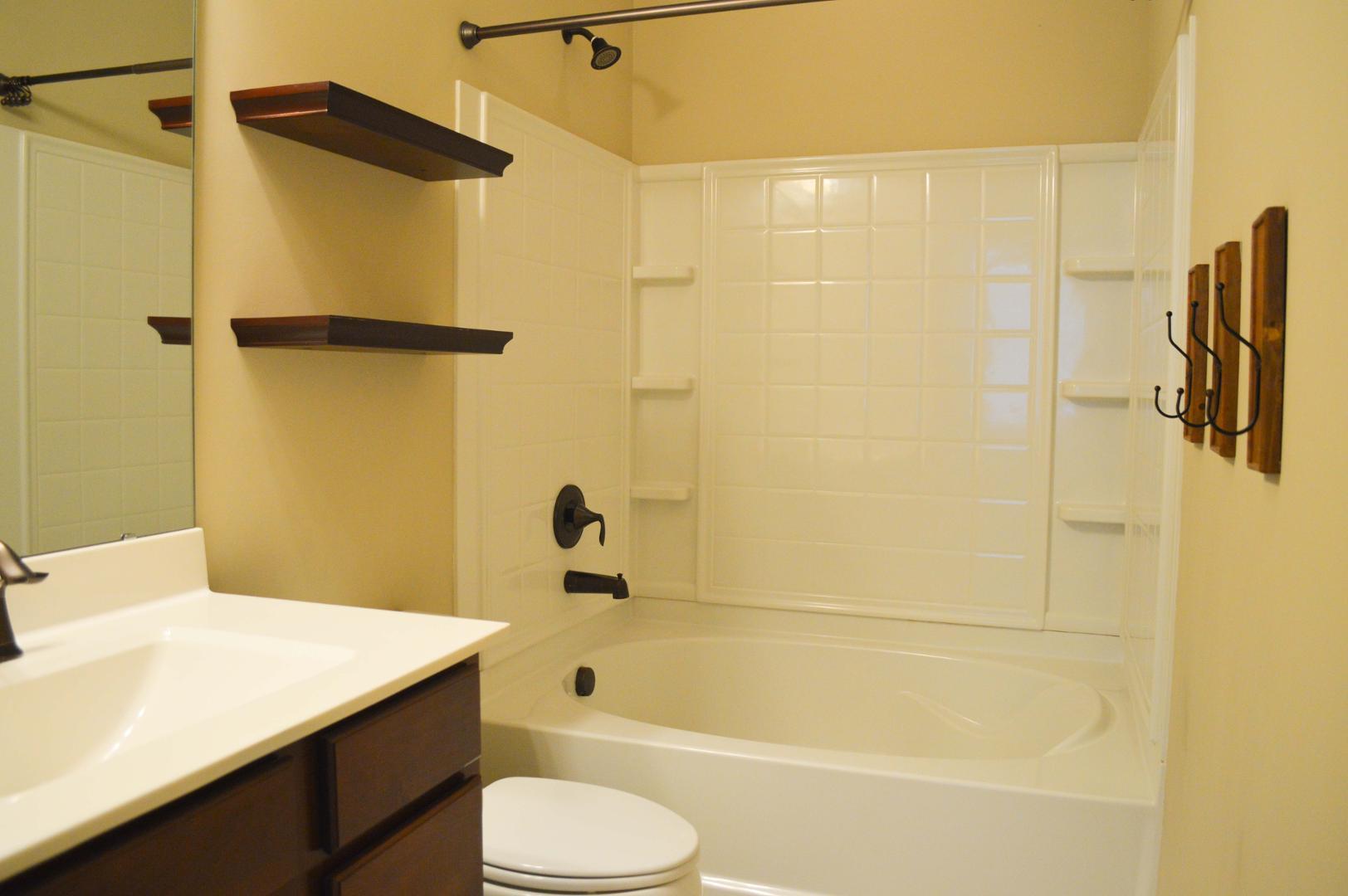720 Wickham Ridge Road Apex, NC 27539 - Photo 14 of 24 a bathroom with a shower curtain and a sink