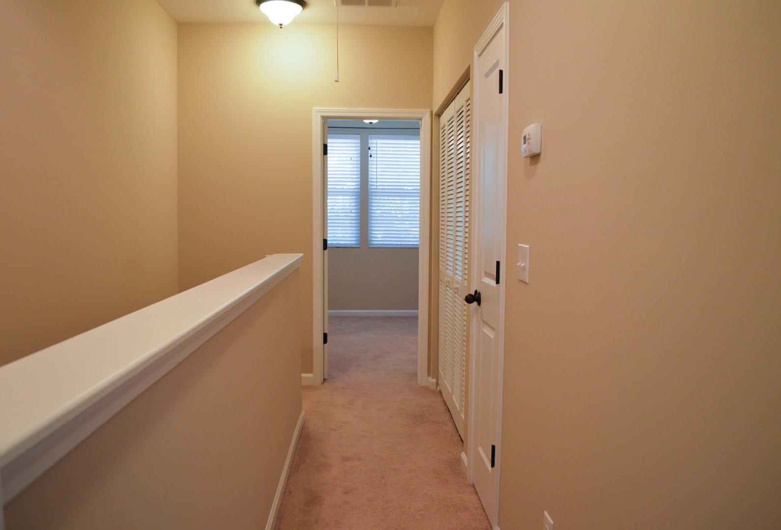 720 Wickham Ridge Road Apex, NC 27539 - Photo 15 of 24 a view of a hallway with a white walls