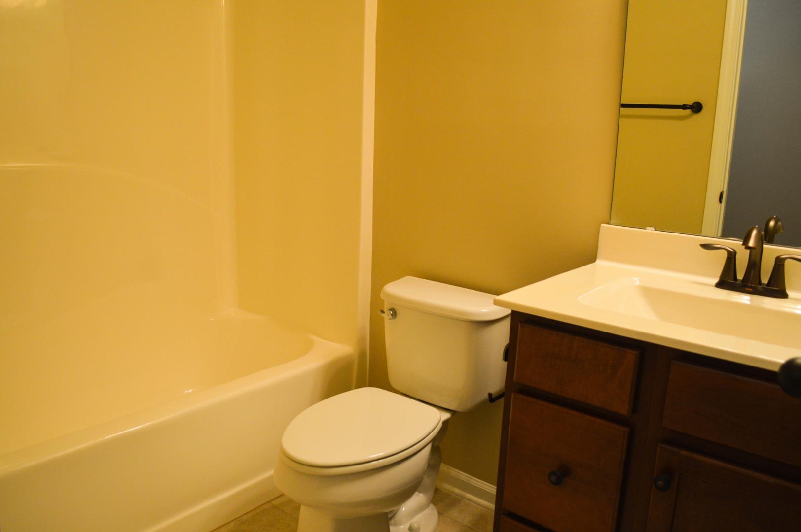 720 Wickham Ridge Road Apex, NC 27539 - Photo 17 of 24 a bathroom with a sink and a toilet