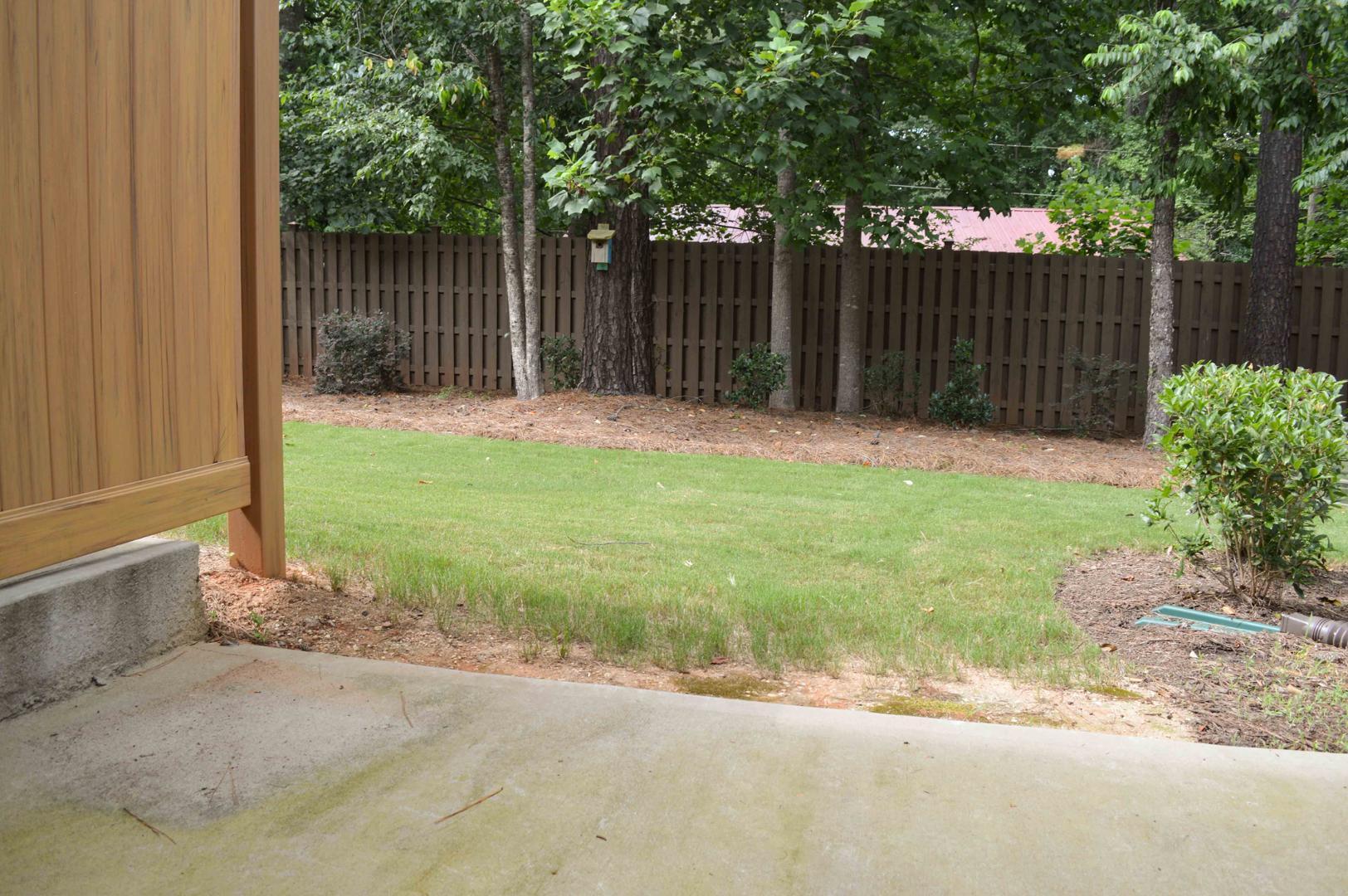 720 Wickham Ridge Road Apex, NC 27539 - Photo 20 of 24 a view of backyard with small cabin and wooden fence