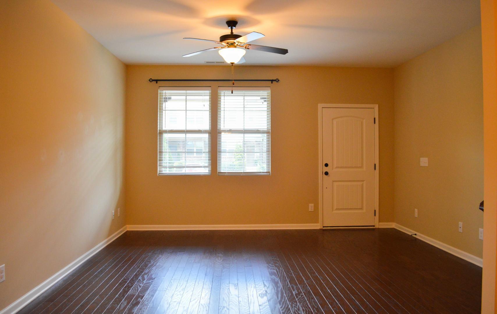 720 Wickham Ridge Road Apex, NC 27539 - Photo 3 of 24 an empty room with wooden floor and windows
