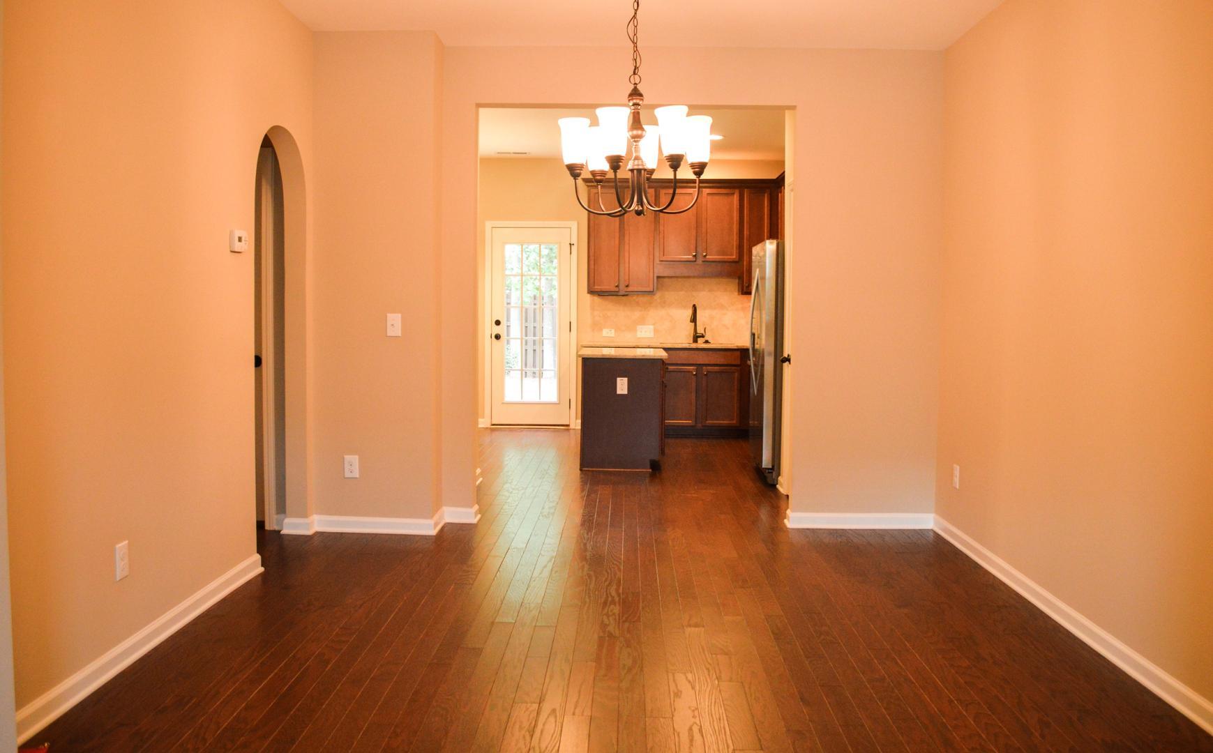720 Wickham Ridge Road Apex, NC 27539 - Photo 6 of 24 a view of a room with wooden floor and furniture