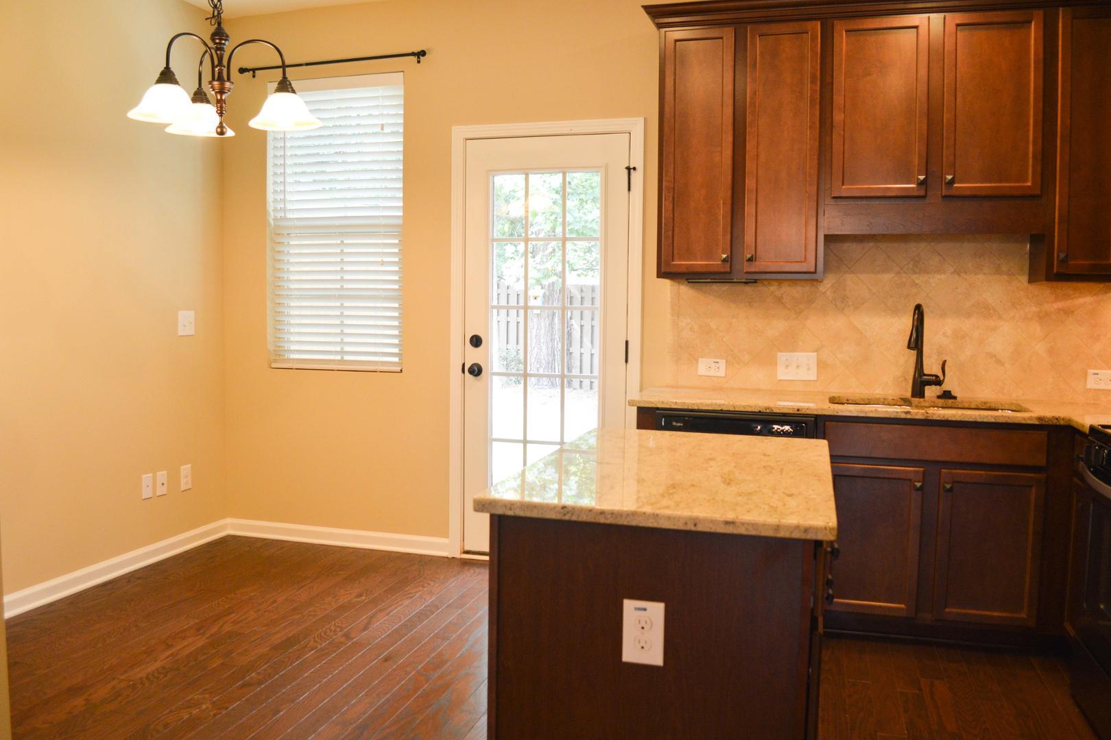 720 Wickham Ridge Road Apex, NC 27539 - Photo 10 of 24 a kitchen with a sink a window and cabinets