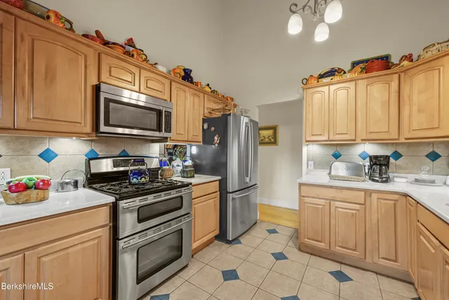 a kitchen with granite countertop a stainless steel appliances and cabinets