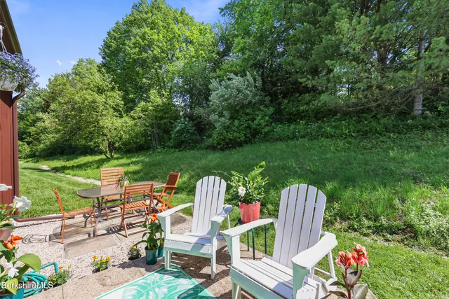 a view of a chairs and table in backyard of the house