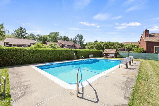 a view of a swimming pool and a lawn chairs
