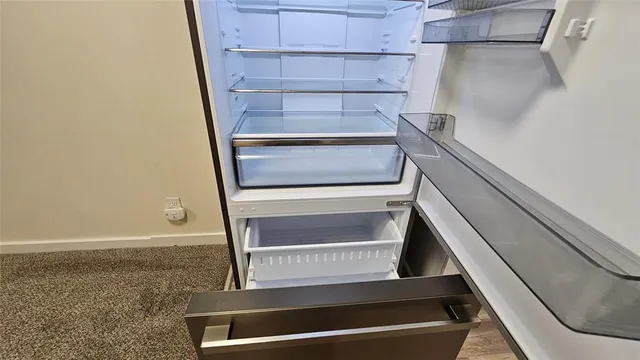 a view of walk in closet with empty racks
