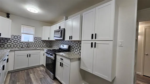 a kitchen with a stove and a microwave