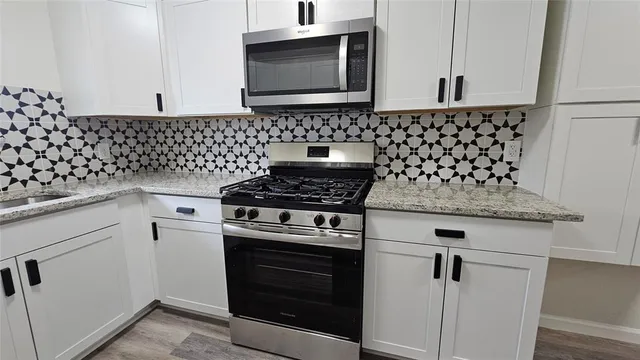 a stove top oven sitting inside of a kitchen