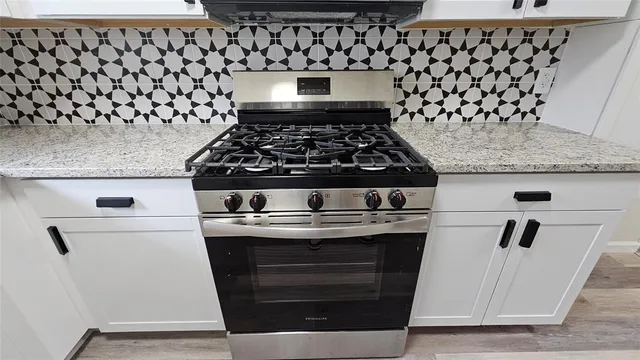 a kitchen with granite countertop cabinets and a sink