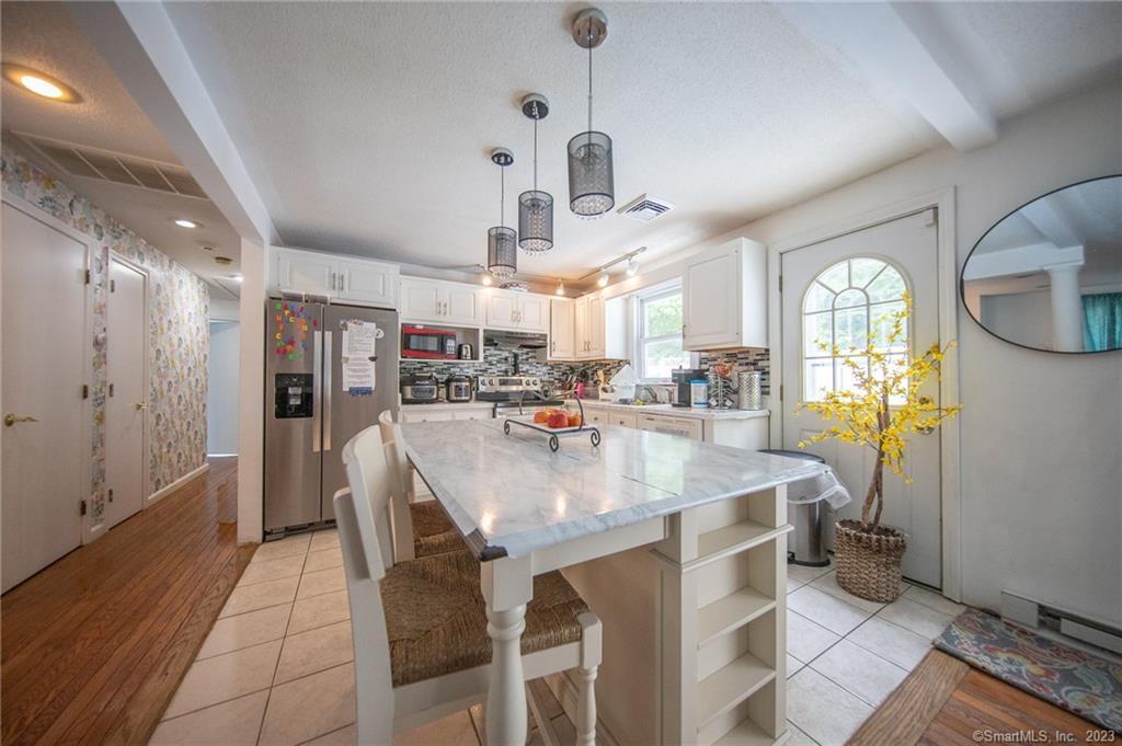 a large kitchen with a table and chairs