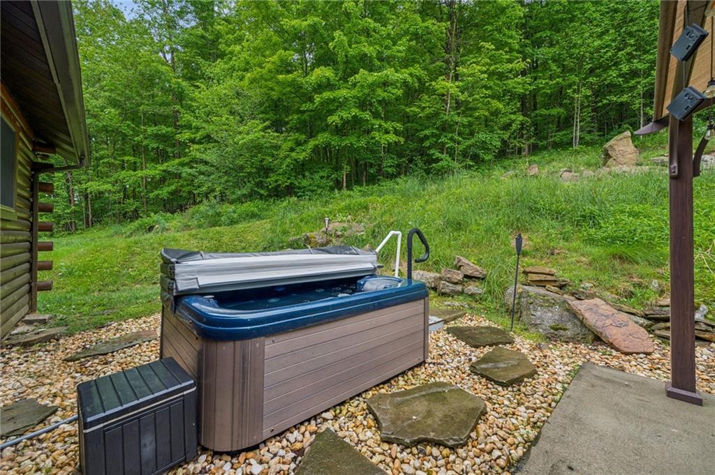 905 Indian Creek Valley Road Normalville, PA 15469 - Photo 9 of 38 a backyard of a house with table and chairs