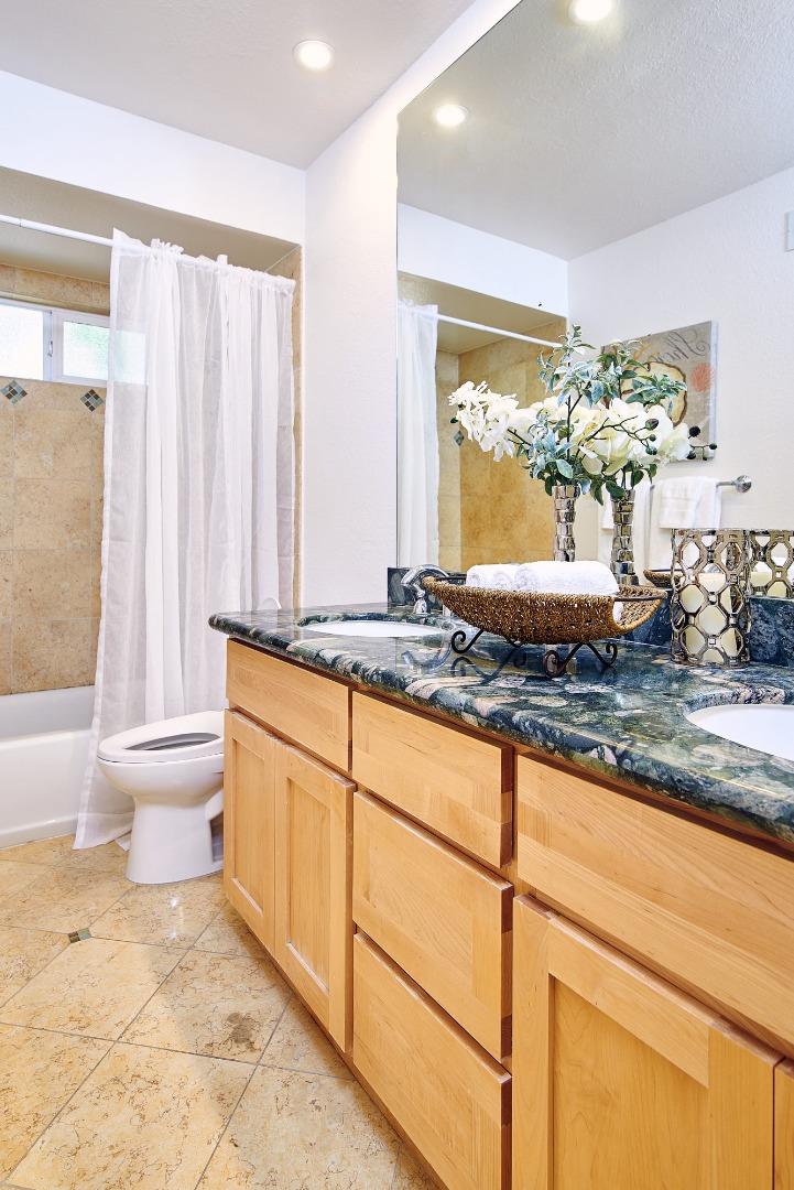 2522 Corte Bella Pleasanton, CA 94566 - Photo 22 of 29 a bathroom with a granite countertop sink and a large mirror
