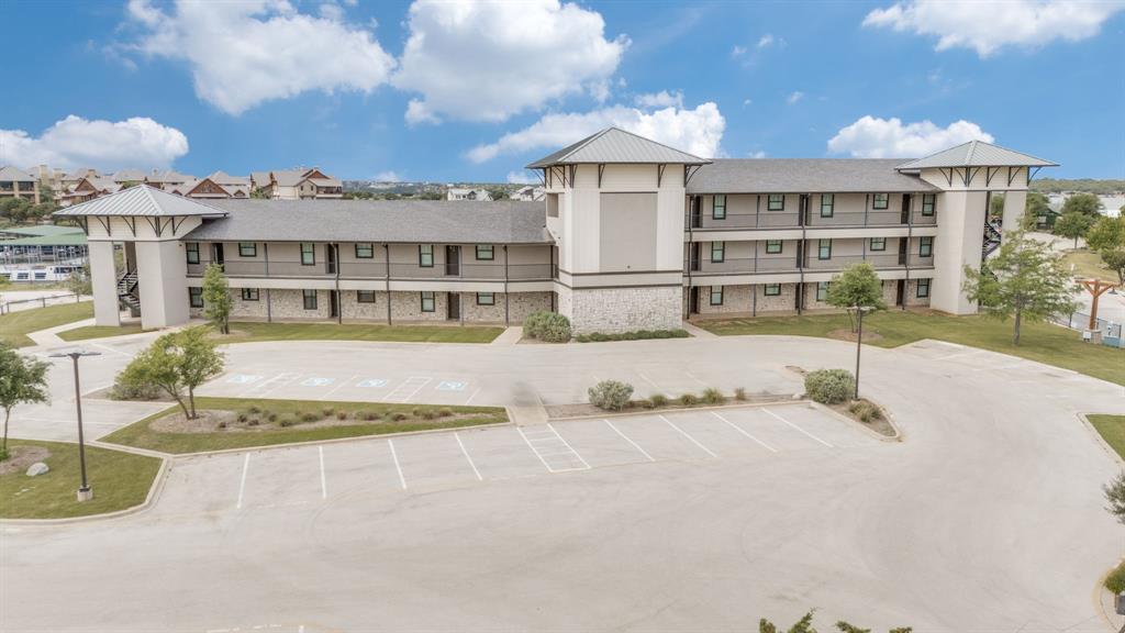 3412 Scenic Point Road, Unit 102 Graford, TX 76449 - Photo 30 of 31 a view of a white house with a swimming pool and sitting area