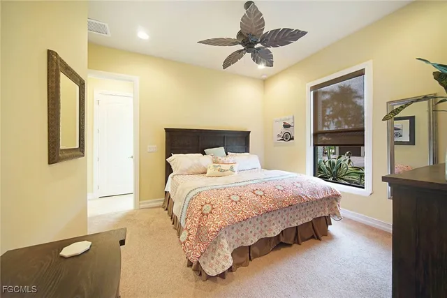 a bed room with furniture and chandelier