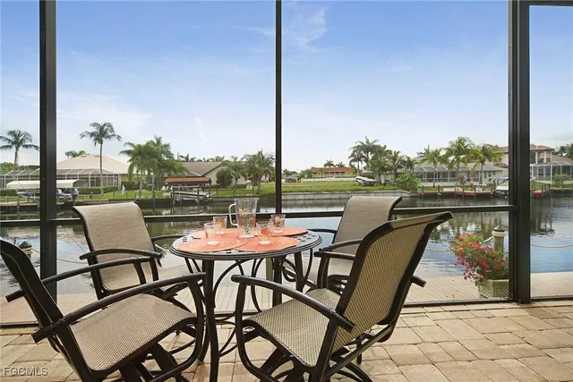 a dining room with furniture a flat screen tv and a floor to ceiling window