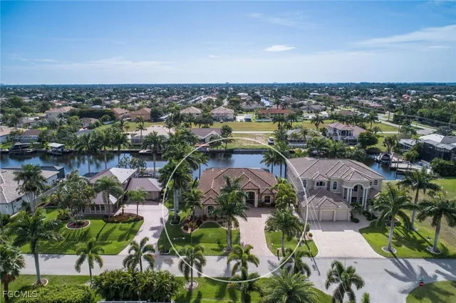 an aerial view of a house with a garden and lake view
