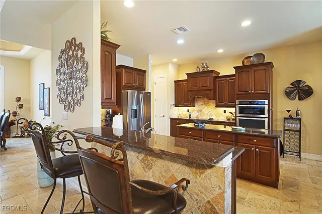 a view of a kitchen with kitchen island granite countertop lots of counter top space and furniture