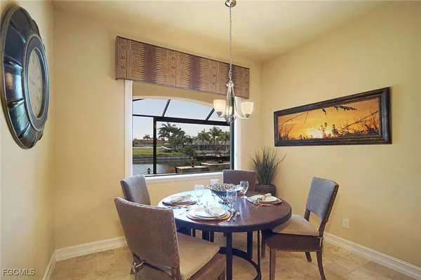a dining room with furniture a window and a chandelier