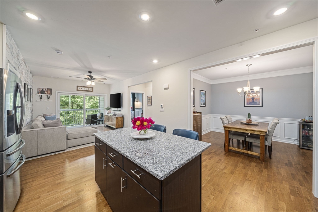 70 Trotter Road, Unit 310 Weymouth, MA 02190 - Photo 1 of 14 a living room with furniture and a wooden floor