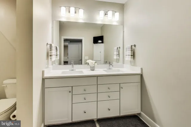 a bathroom with a sink vanity and a mirror