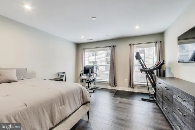 a spacious bedroom with two beds and a desk