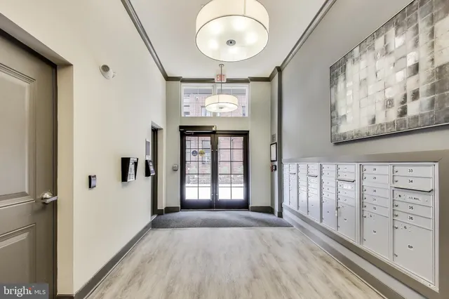 a view of a hallway with wooden floor and entryway