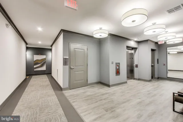 a view of a hallway with wooden floor