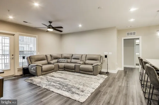 a living room with furniture and a wooden floor